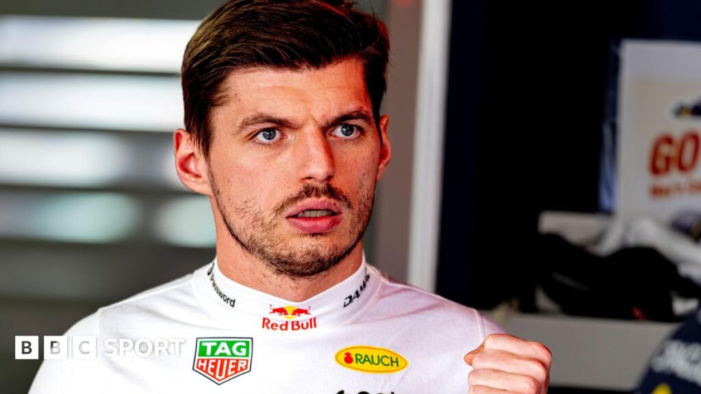 Max Verstappen wearing a white fireproof top in the Red Bull garage at the Japanese Grand Prix